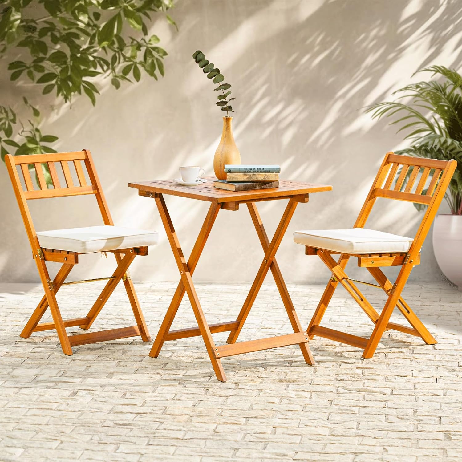 A foldable bistro set with a round table and two chairs