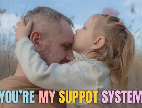 a dad and child kissing father's forehead