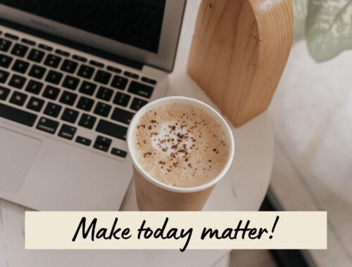 A bright workspace with a laptop, coffee, and a note reading, “Make today matter!”
