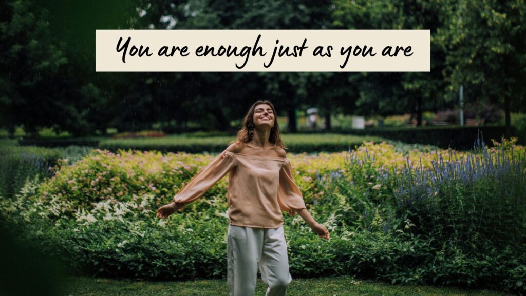 Woman smiling in a garden with quote, “You are enough just as you are,” for you are beautiful quotes.